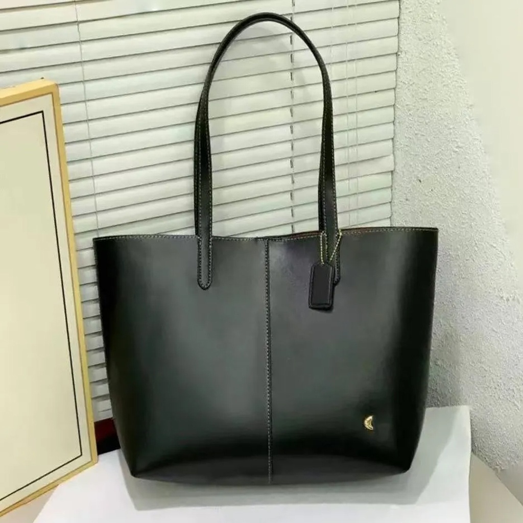 Cartera Coach de cuero para mujer.